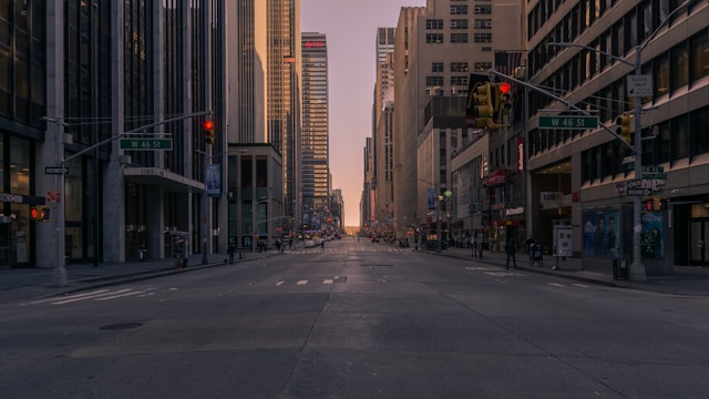 gray-concrete-road-between-buildings